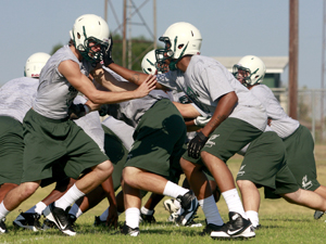 Ellison football players run drills